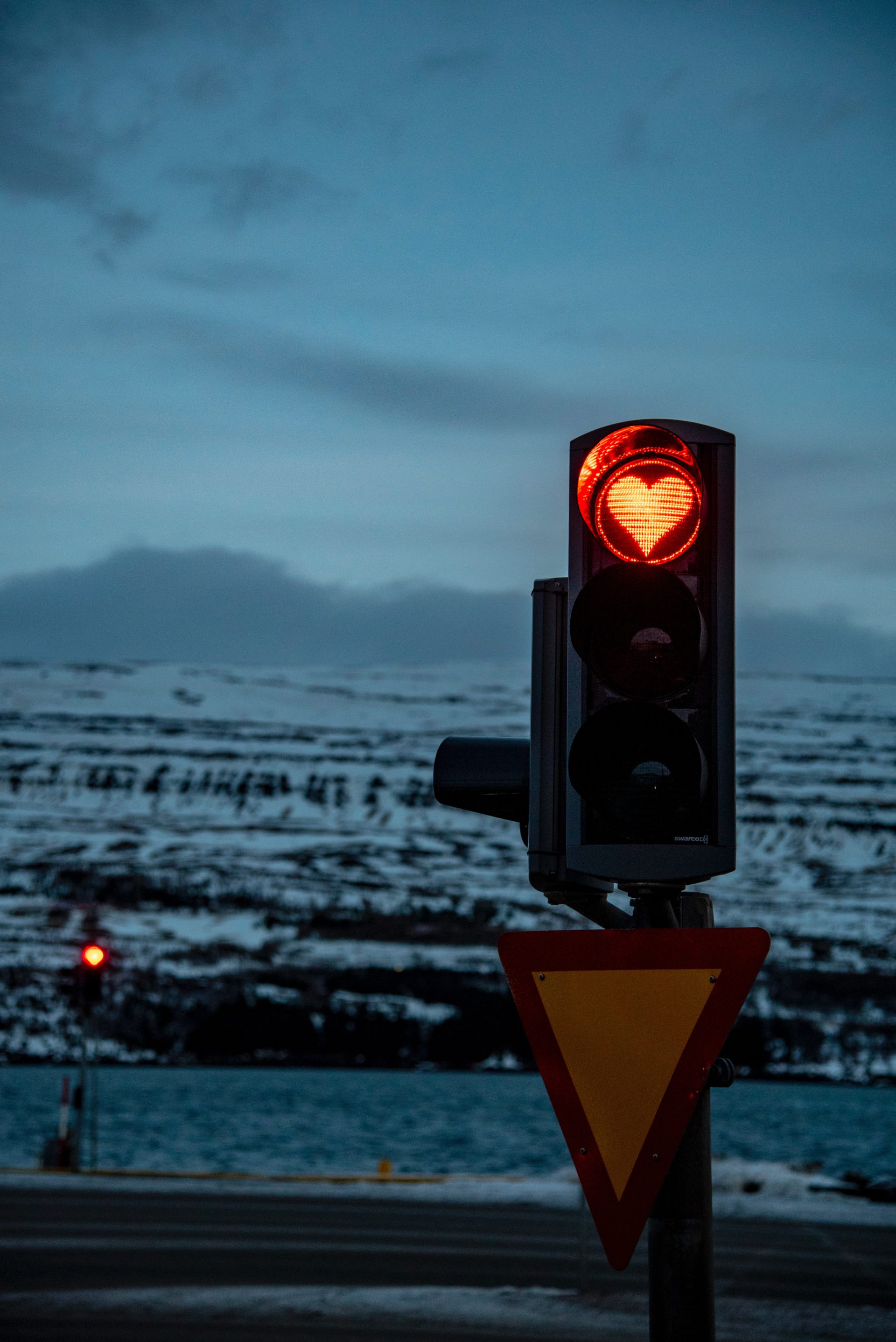 image showing a traffic red light with the shape of a red heart