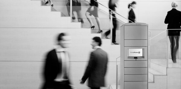 Business people walking on busy office staircase