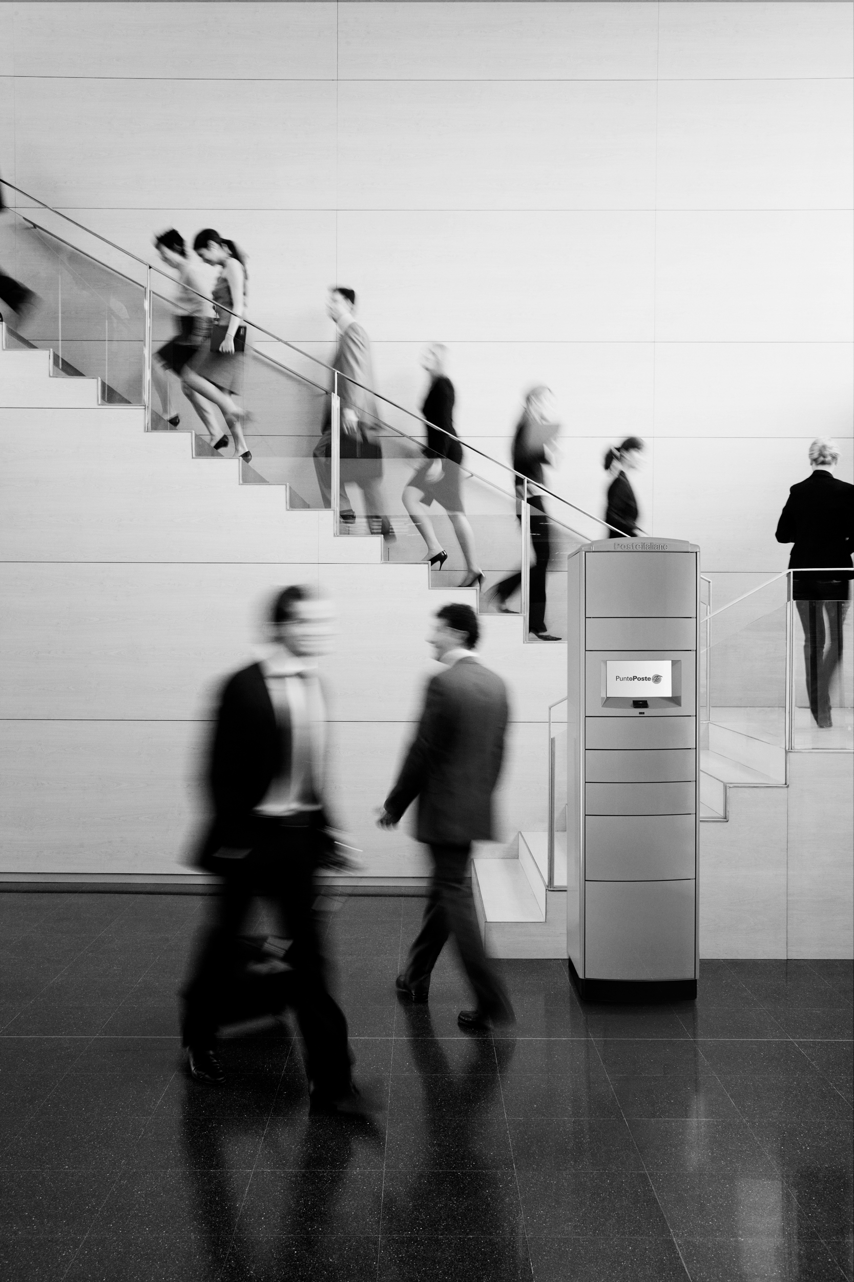 Business people walking on busy office staircase